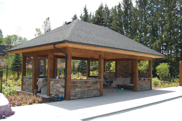 Gazebo on concrete with a garden to the side